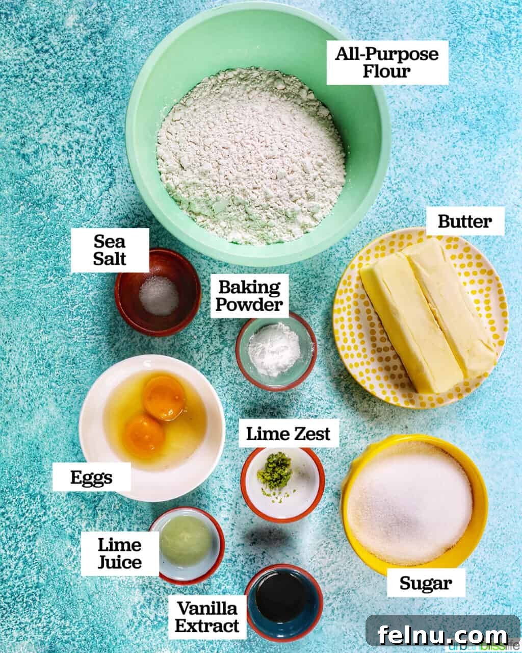 Tangy Key Lime Delights 5 Several small bowls containing various ingredients for baking key lime sugar cookies, including flour, sugar, butter, and eggs, all arranged on a blue background.