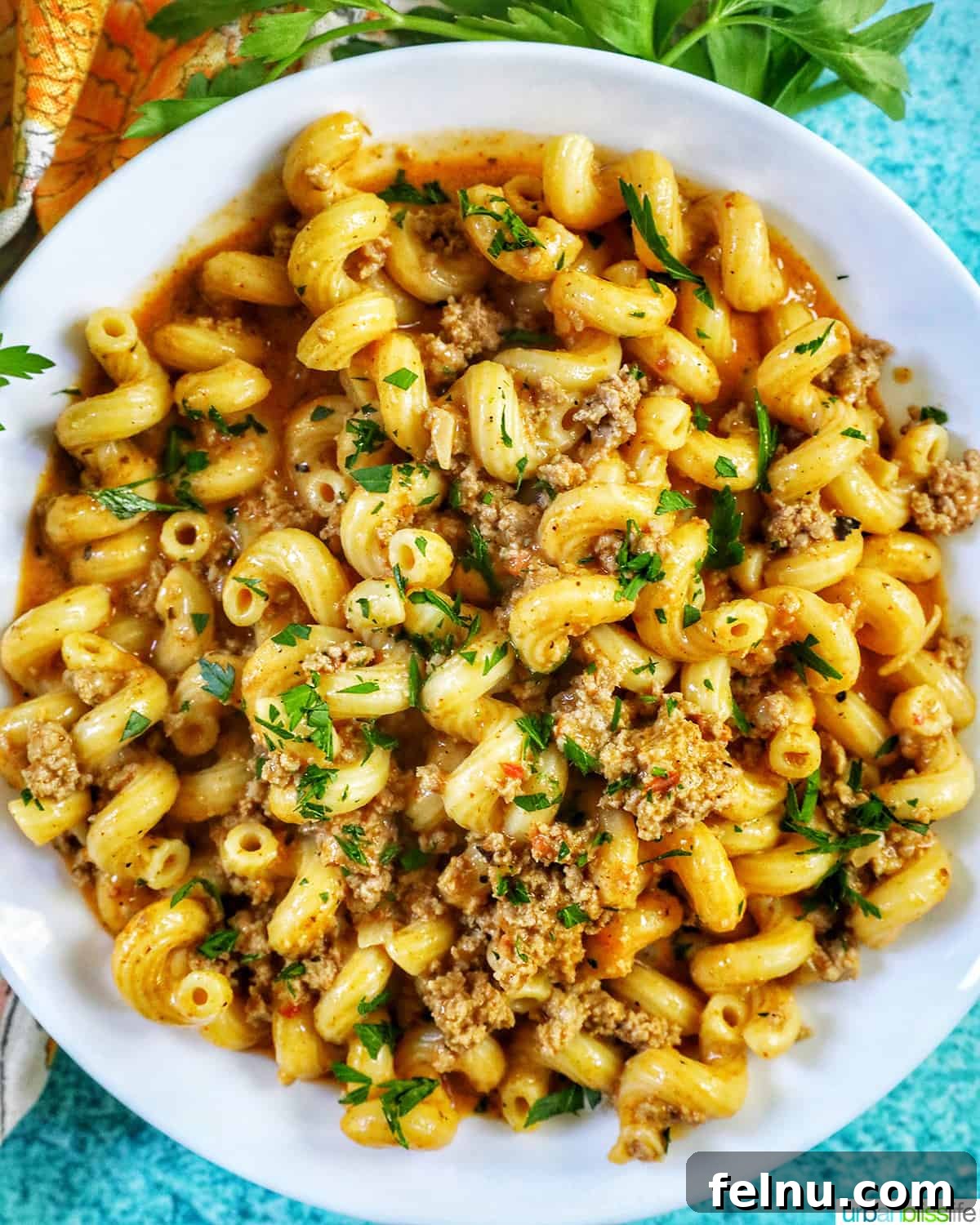 Creamy Dairy-Free Cheeseburger Mac Skillet 2 A hearty bowl of dairy-free one-pot cheeseburger pasta, garnished with fresh chopped parsley and featuring lean ground turkey.