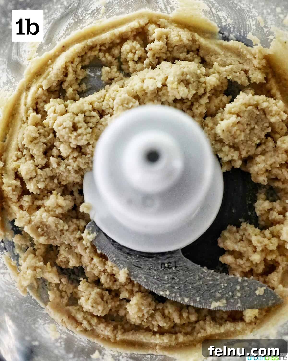 Zingy Mint Pesto 6 Finely blended pine nuts forming a thick paste at the bottom of a food processor bowl.