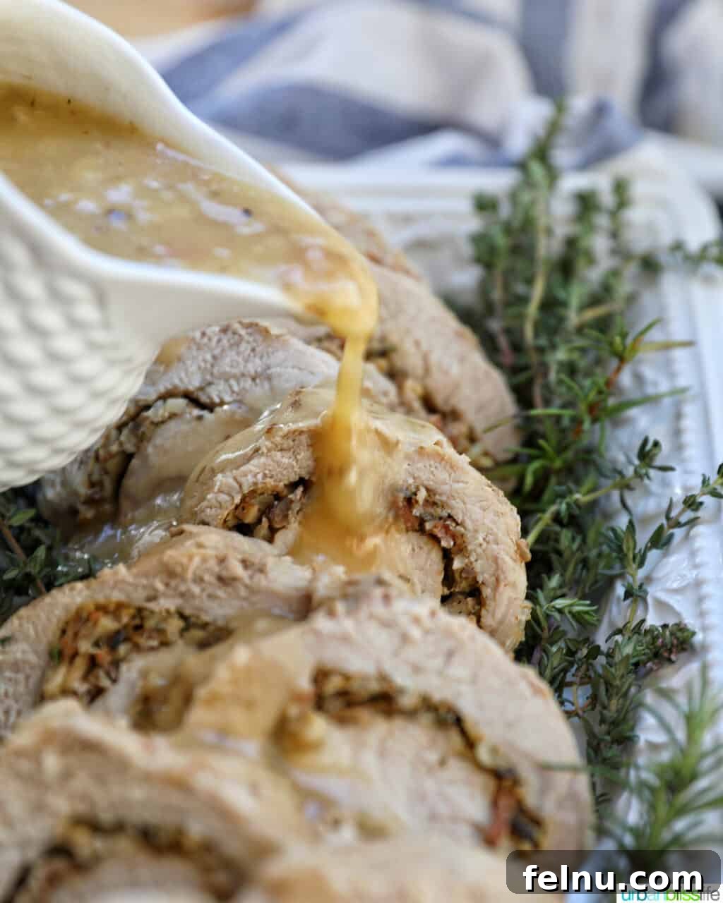 Instant Pot Pork Loin: A Flavorful One-Pot Wonder 3 Gravy pouring over sliced stuffed pork loin