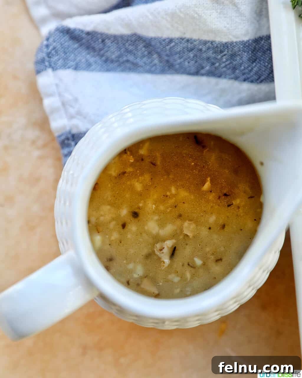 Instant Pot Pork Loin: A Flavorful One-Pot Wonder 24 Gravy in a white pitcher
