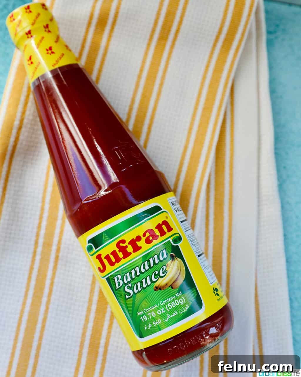 Building Your Essential Filipino Pantry 6 bottle of Filipino banana ketchup on a white and yellow striped towel.