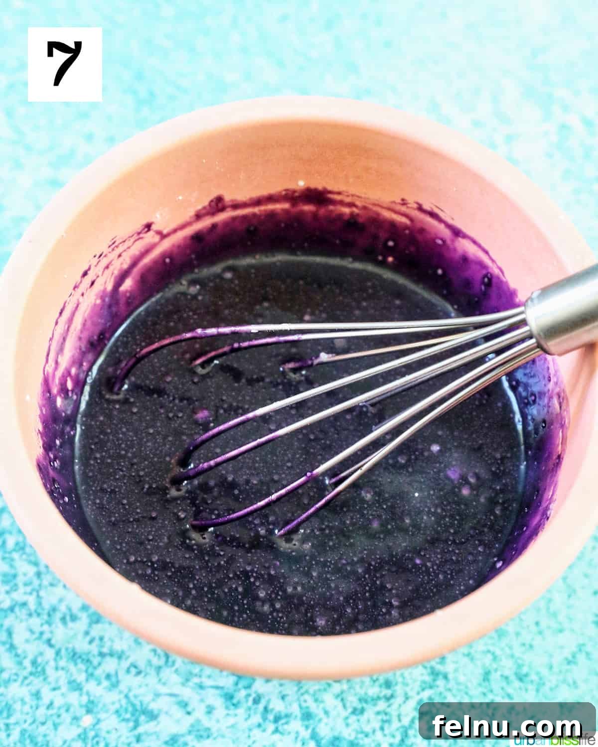 Ube Dream Donuts 15 Whisk in a bowl of purple ube glaze.