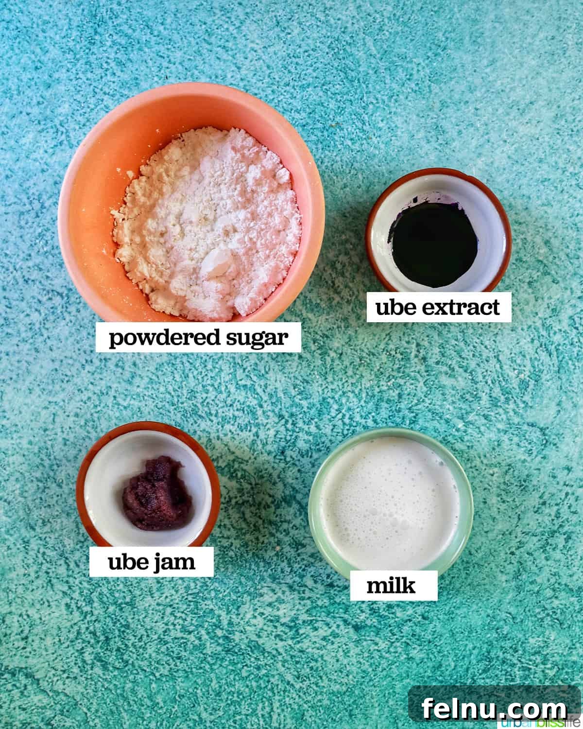 Ube Dream Donuts 5 Four bowls displaying the ingredients required to prepare the mesmerizing purple ube glaze, elegantly presented on a calming blue background.