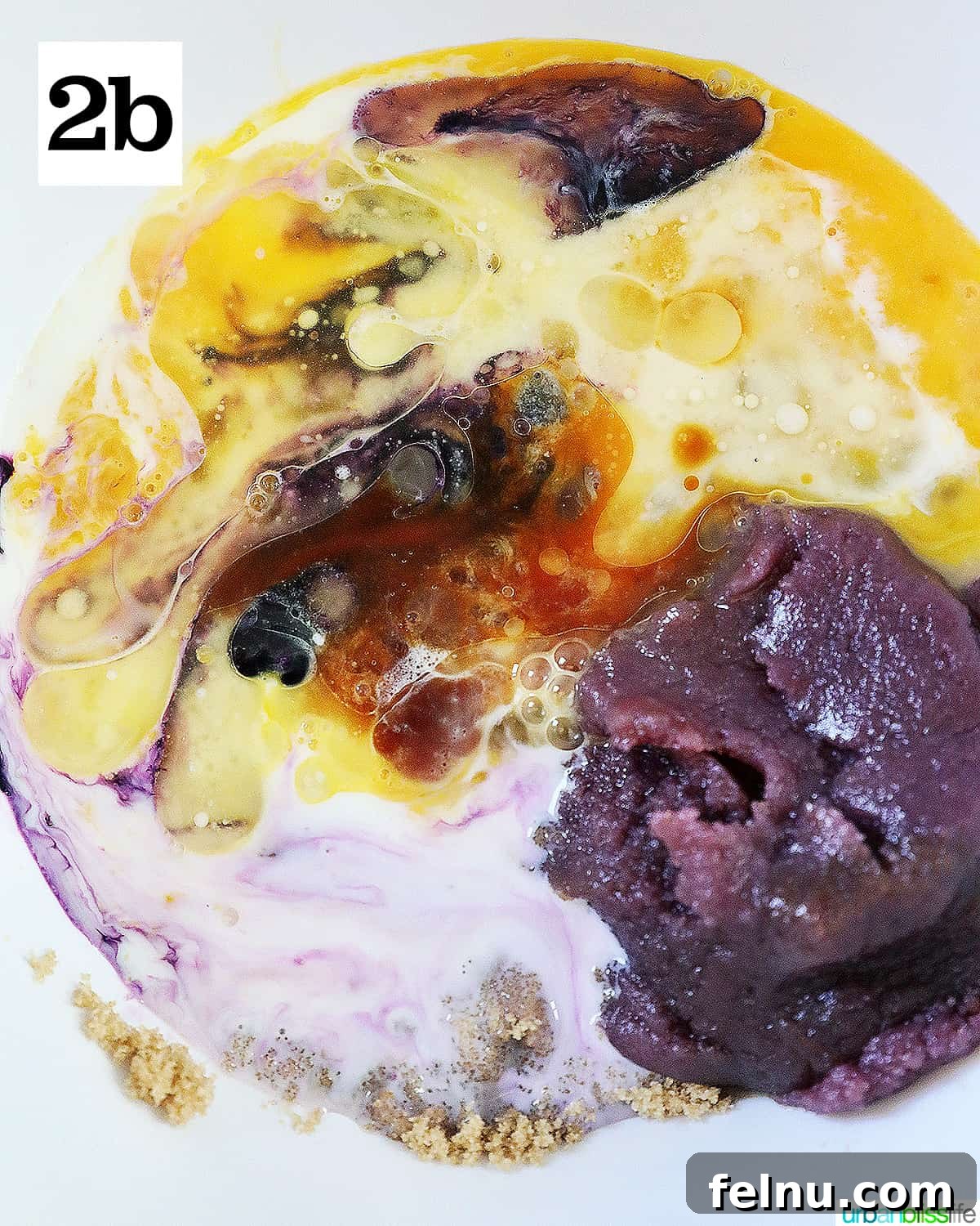 Ube Dream Donuts 8 Ube jam, eggs, vanilla, brown sugar in a white bowl to make ube donuts batter.
