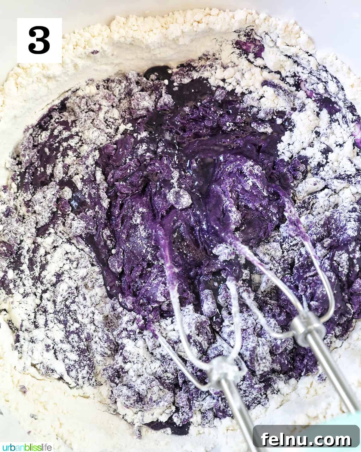 Ube Dream Donuts 9 Whisk in a white bowl with ube batter and flour dry ingredients.
