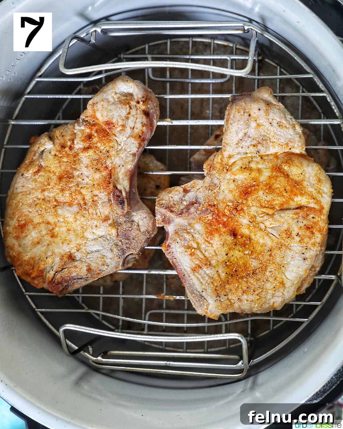 Instant Pot Pork Chop Rice Bowl 12 Two seasoned pork chops on top of a rack inside a Ninja Foodi pressure cooker.