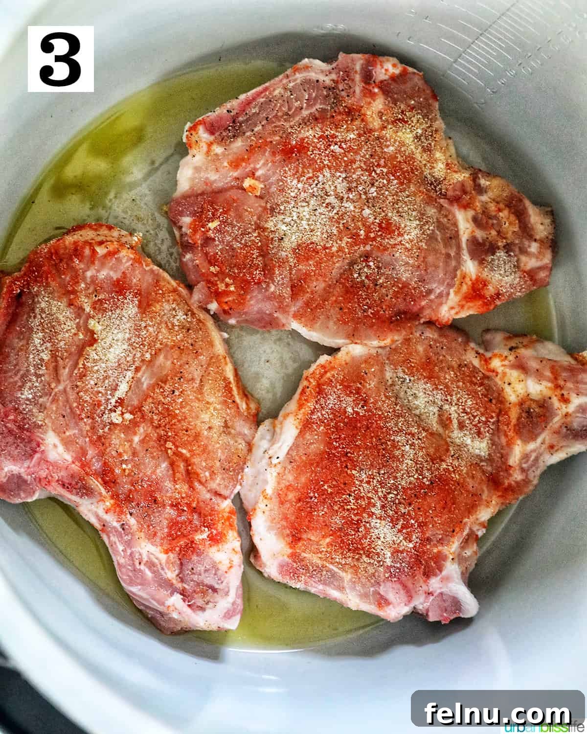Instant Pot Pork Chop Rice Bowl 7 Three seasoned pork chops being sautéed in the inner pot of a Ninja Foodi or Instant Pot.