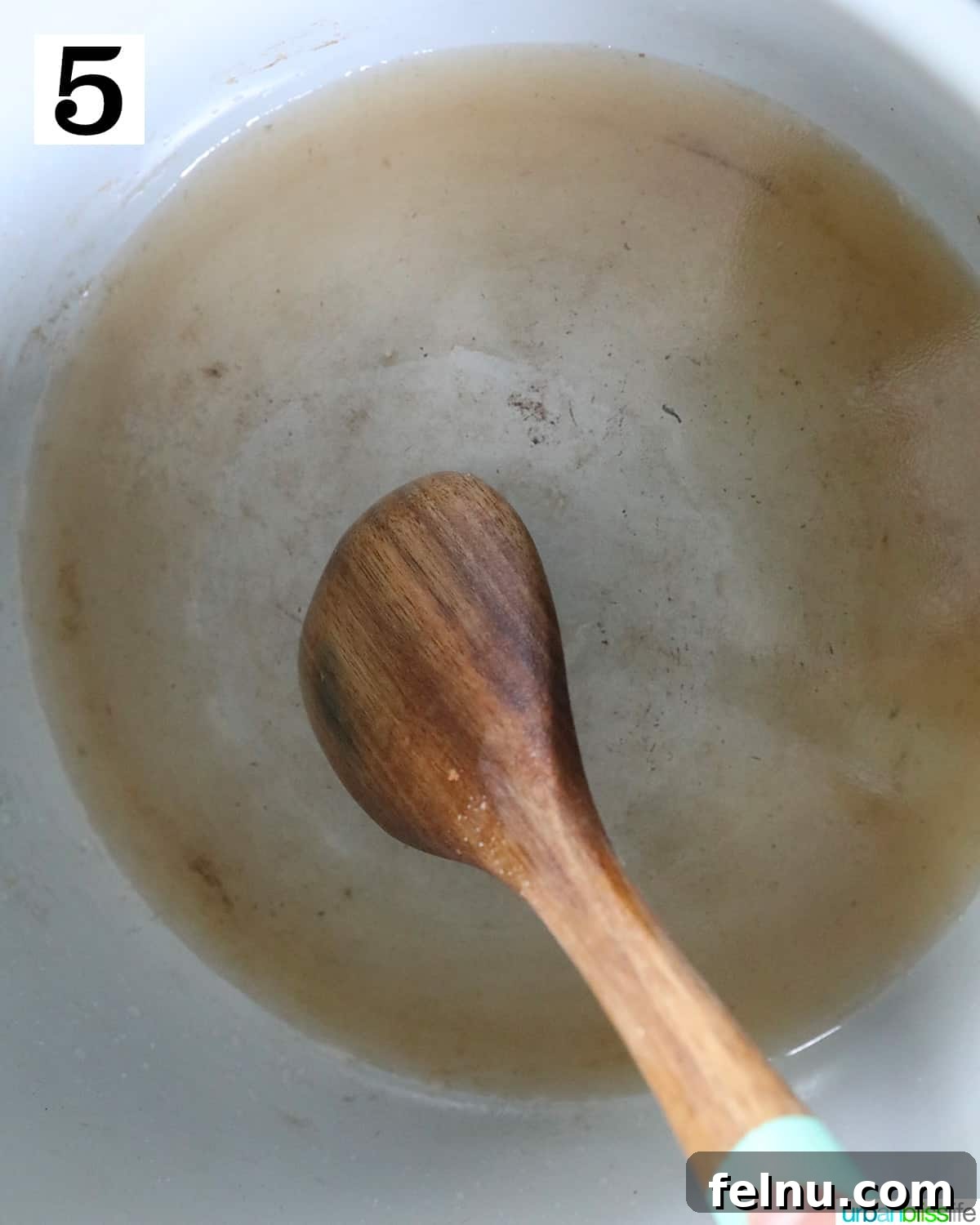 Instant Pot Pork Chop Rice Bowl 9 Using a wooden spoon to scrape up browned bits from the bottom of a Ninja Foodi pressure cooker or Instant Pot.
