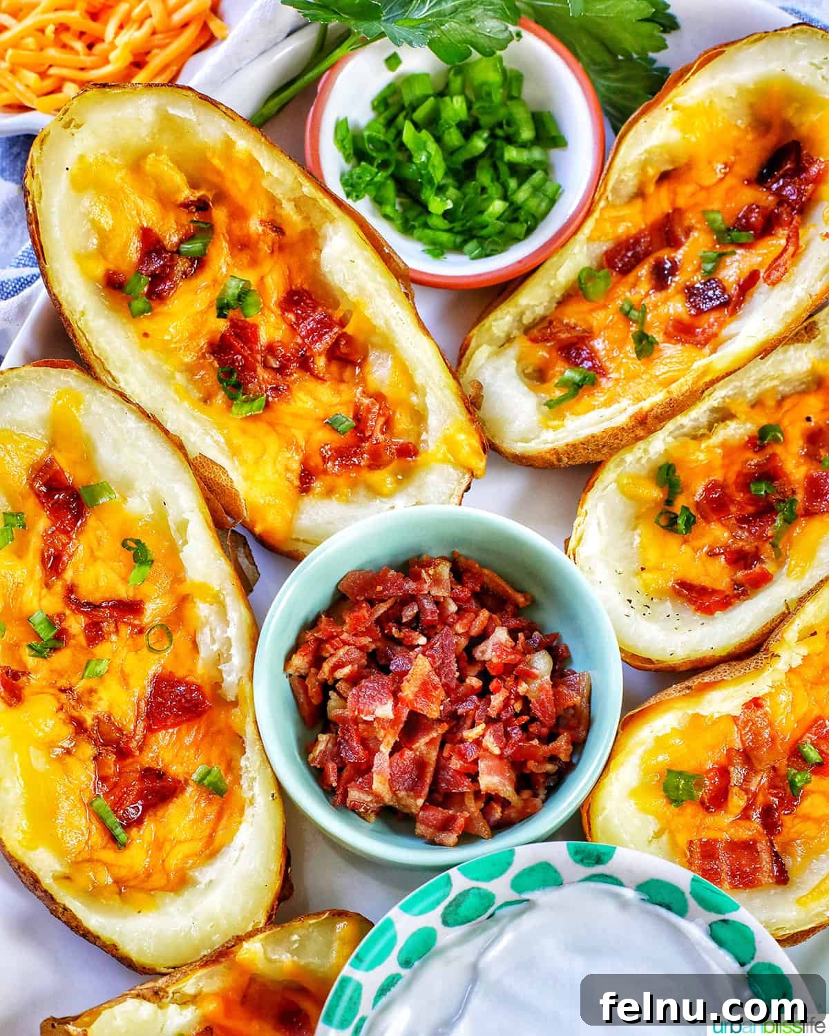 Ultimate Air Fryer Potato Skins 2 several air fryer potato skins with sides of green onions, bacon, and sour cream.