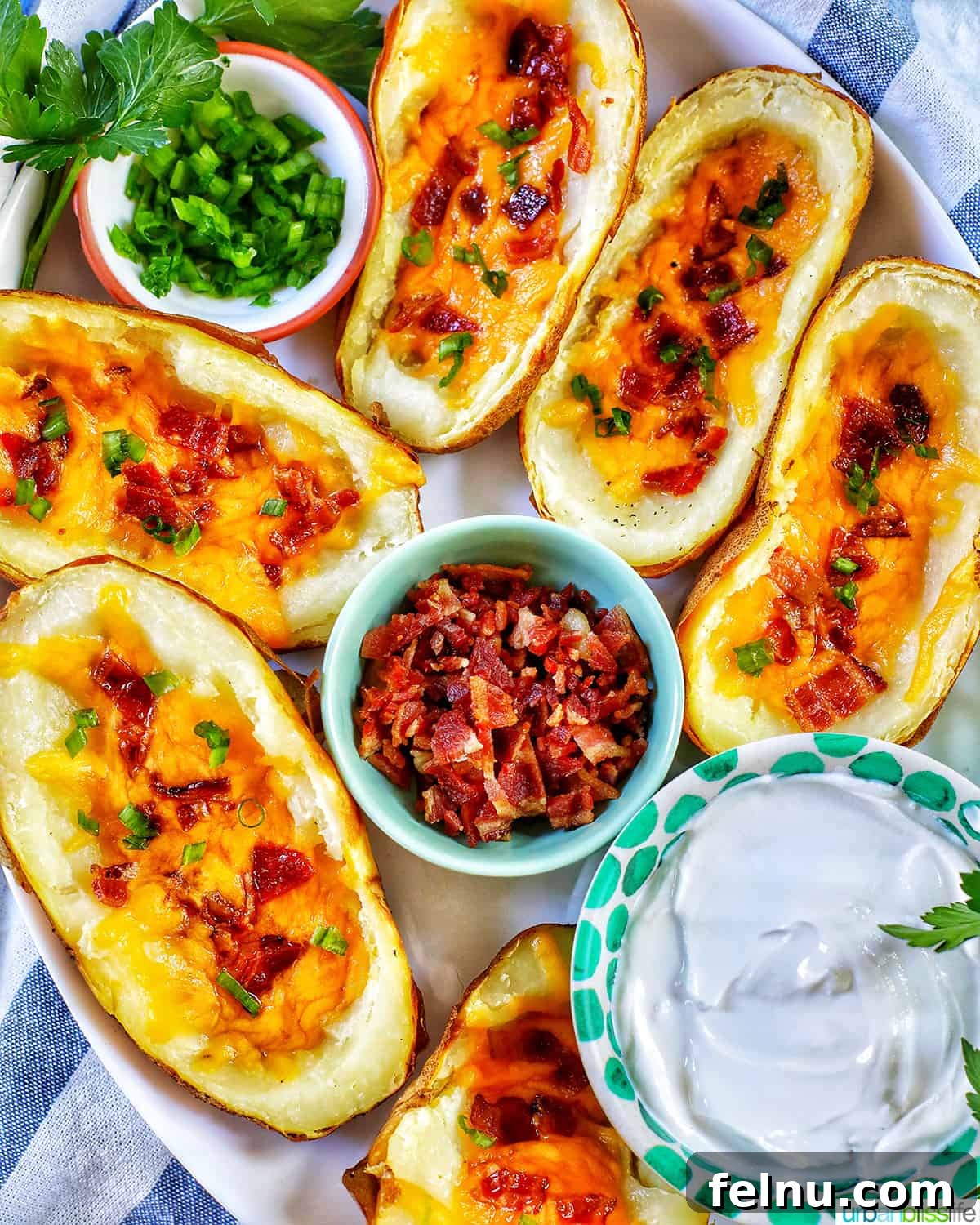 Ultimate Air Fryer Potato Skins 14 several air fryer potato skins with sides of green onions, bacon, and sour cream.