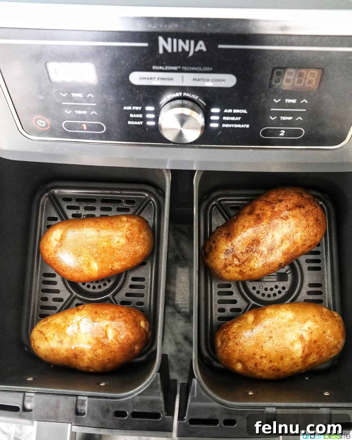 Ultimate Air Fryer Potato Skins 15 four potatoes in an air fryer.