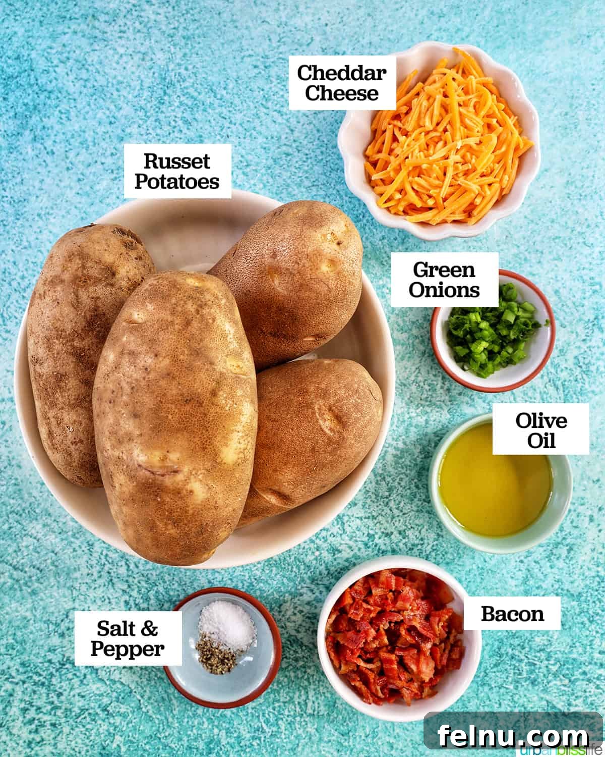 Ultimate Air Fryer Potato Skins 4 bowls full of individual ingredients to make Air Fryer Potato Skins on a blue background.