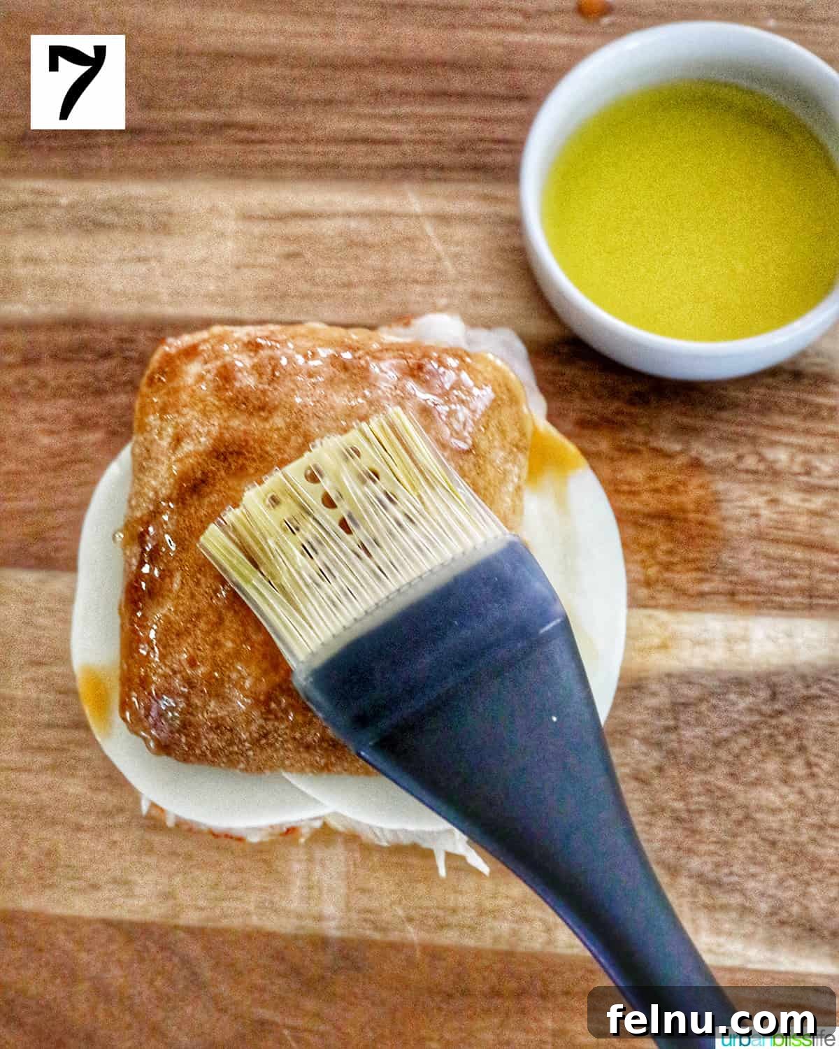 Brushing melted butter on the top of the sandwich