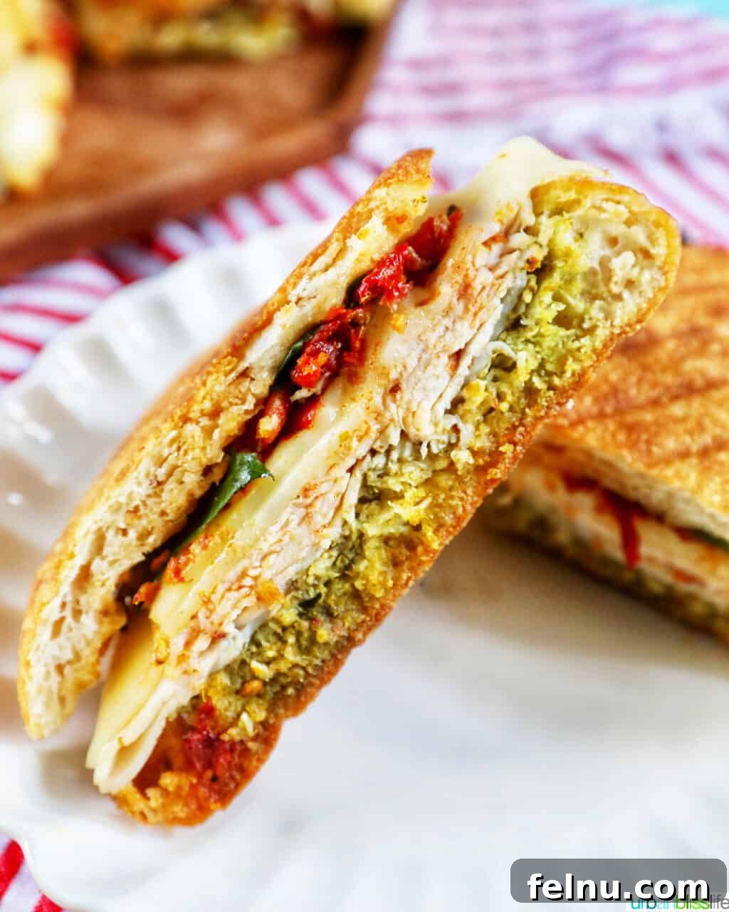 Close-up of a Turkey Pesto Sandwich cut in half, showcasing the layers