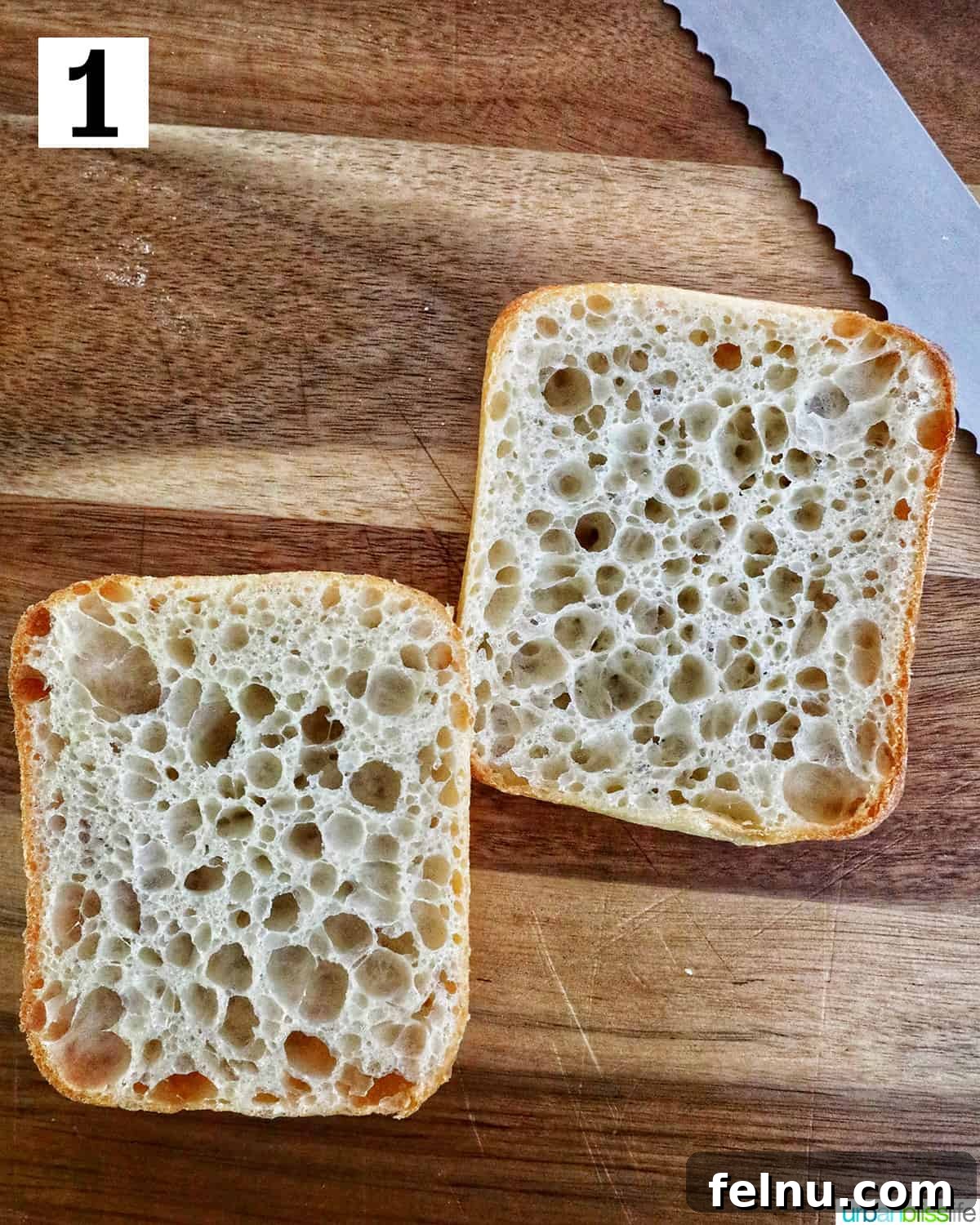 Ciabatta bread being sliced on a cutting board