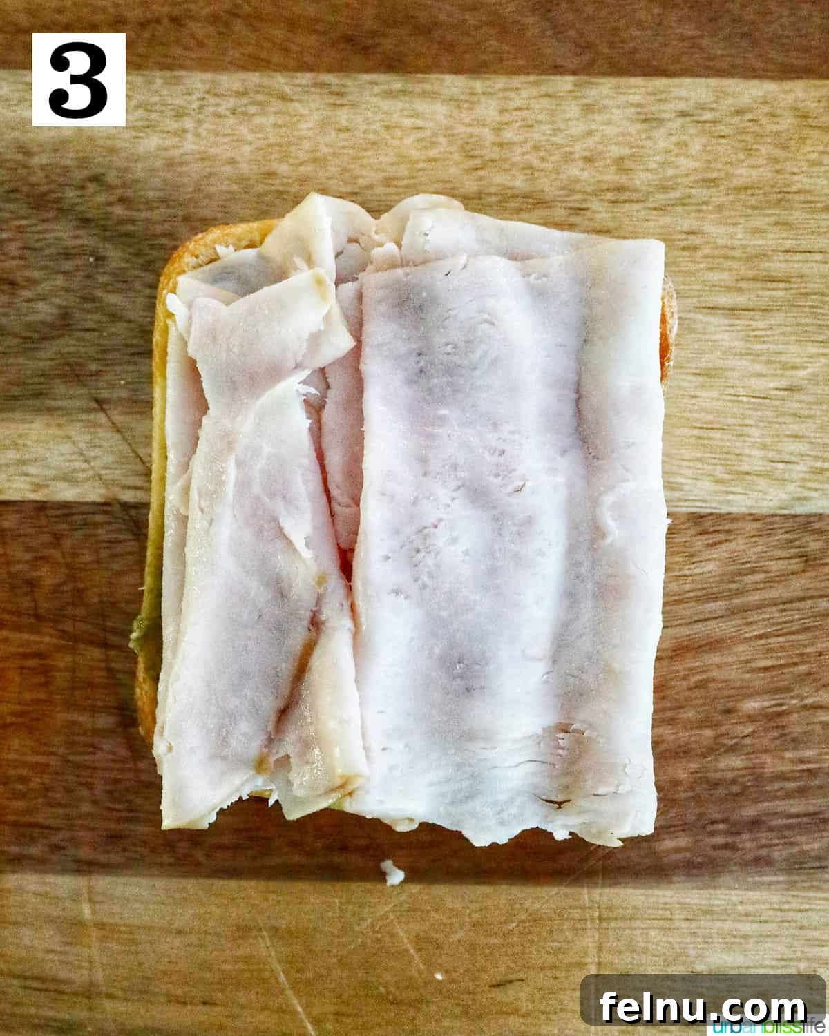 Adding sliced turkey to the ciabatta bread