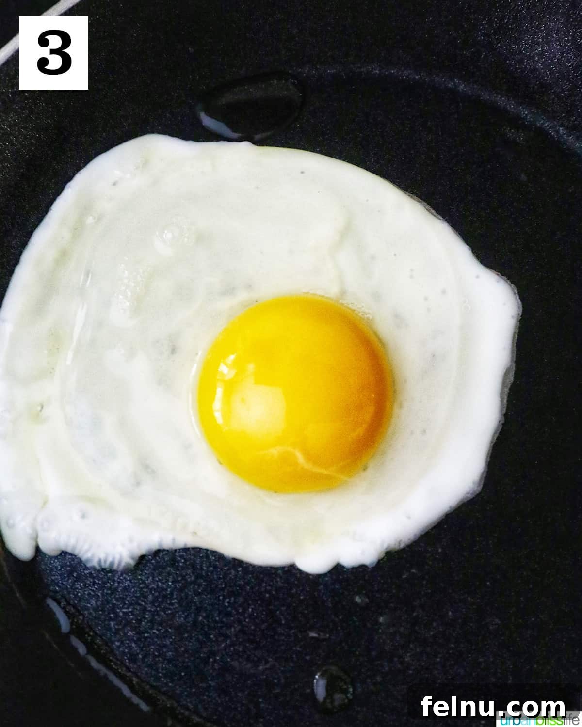 Spamsilog A Filipino Breakfast Classic 7 Egg over easy frying in a nonstick skillet.