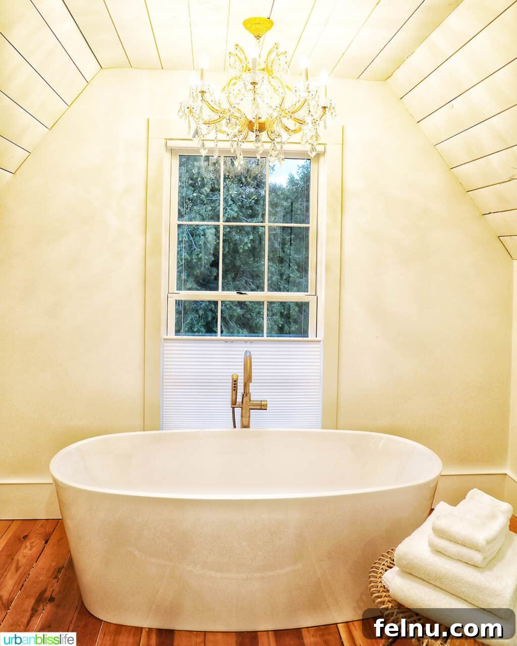 A large bathtub and elegant chandelier in Kubli Haus Suite 3 in Jacksonville, Oregon.