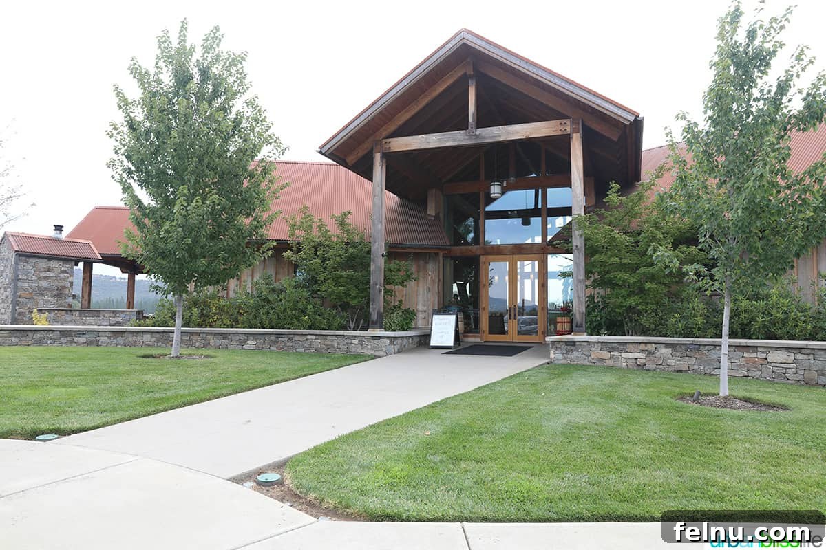 Kriselle Cellars Oregon Wine Country Gem 5 The grand, inviting exterior of the Kriselle Cellars wine tasting room, featuring stone architecture and expansive windows that welcome visitors to Southern Oregon's wine country.