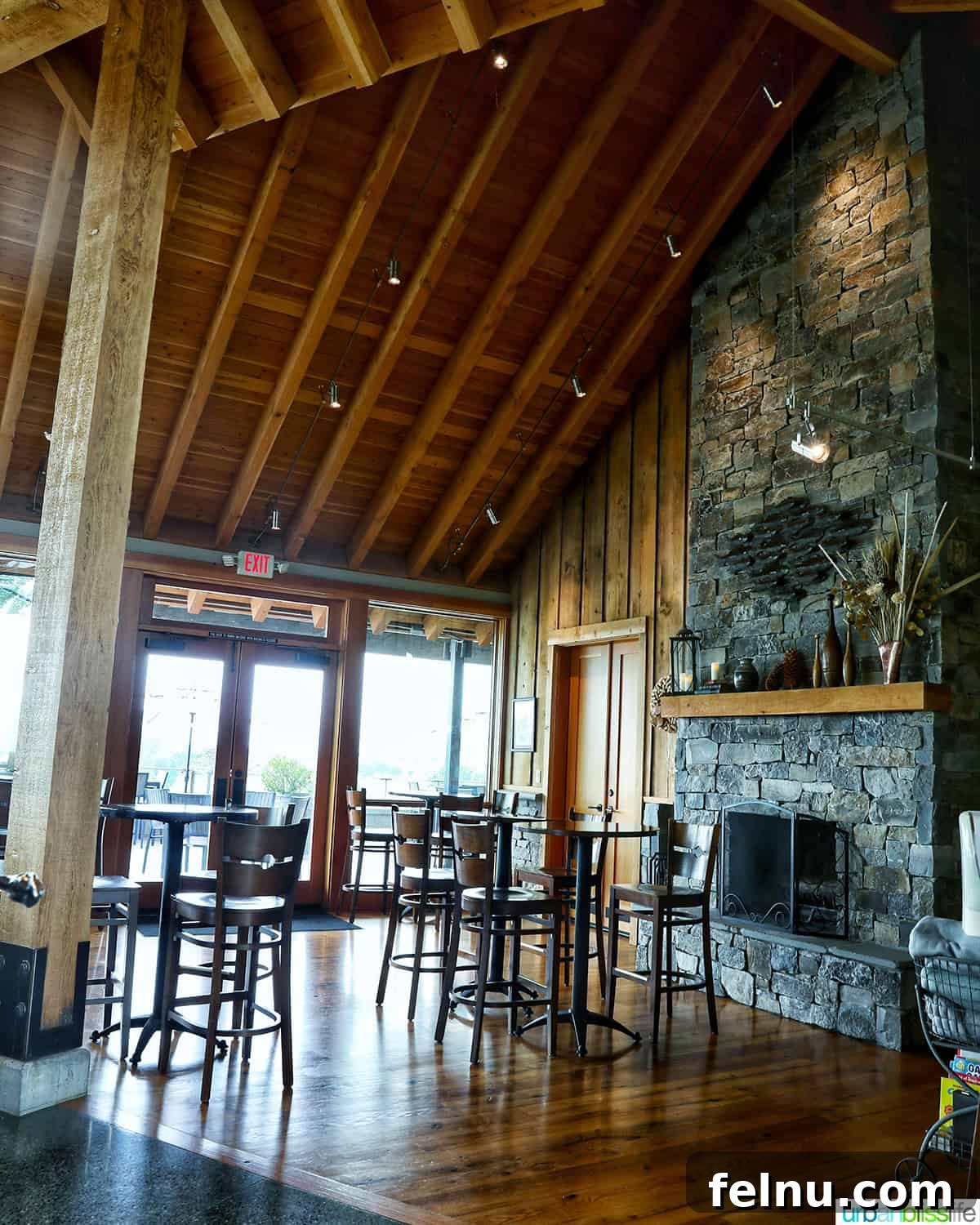 Kriselle Cellars Oregon Wine Country Gem 7 The elegant and spacious interior of the Kriselle Cellars tasting room, featuring high wooden beam ceilings, a grand stone fireplace, and comfortable seating arrangements.