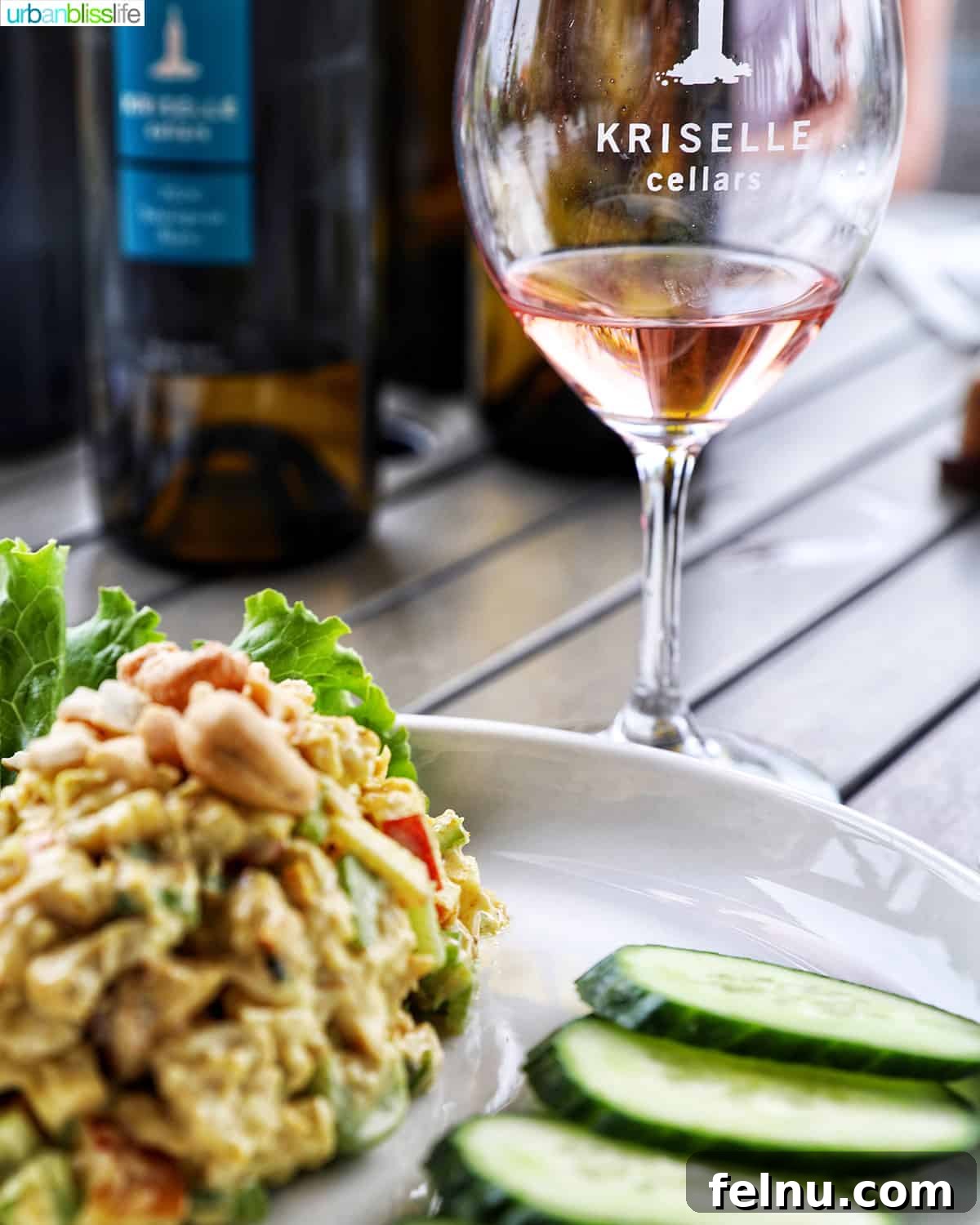 Kriselle Cellars Oregon Wine Country Gem 10 A refreshing curry chicken salad with crisp cucumbers, elegantly paired with a bottle and glass of Kriselle Cellars Grenache Rosé, promising a delightful culinary experience.