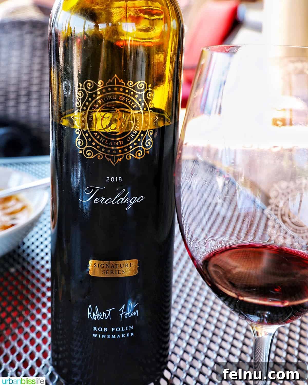 Bottle of teradelgo wine with glass of red wine next to it.