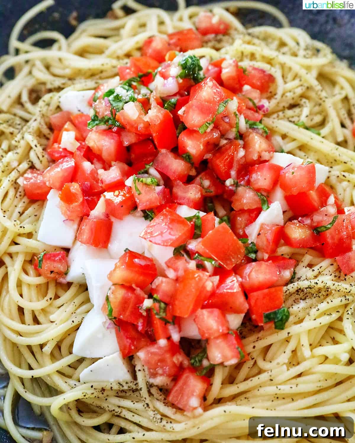 Bruschetta pasta with tomatoes, basil, and mozzarella cheese.