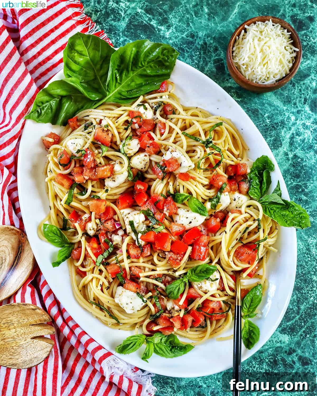 Bruschetta pasta with tomatoes, basil, and mozzarella cheese in a big serving bowl.