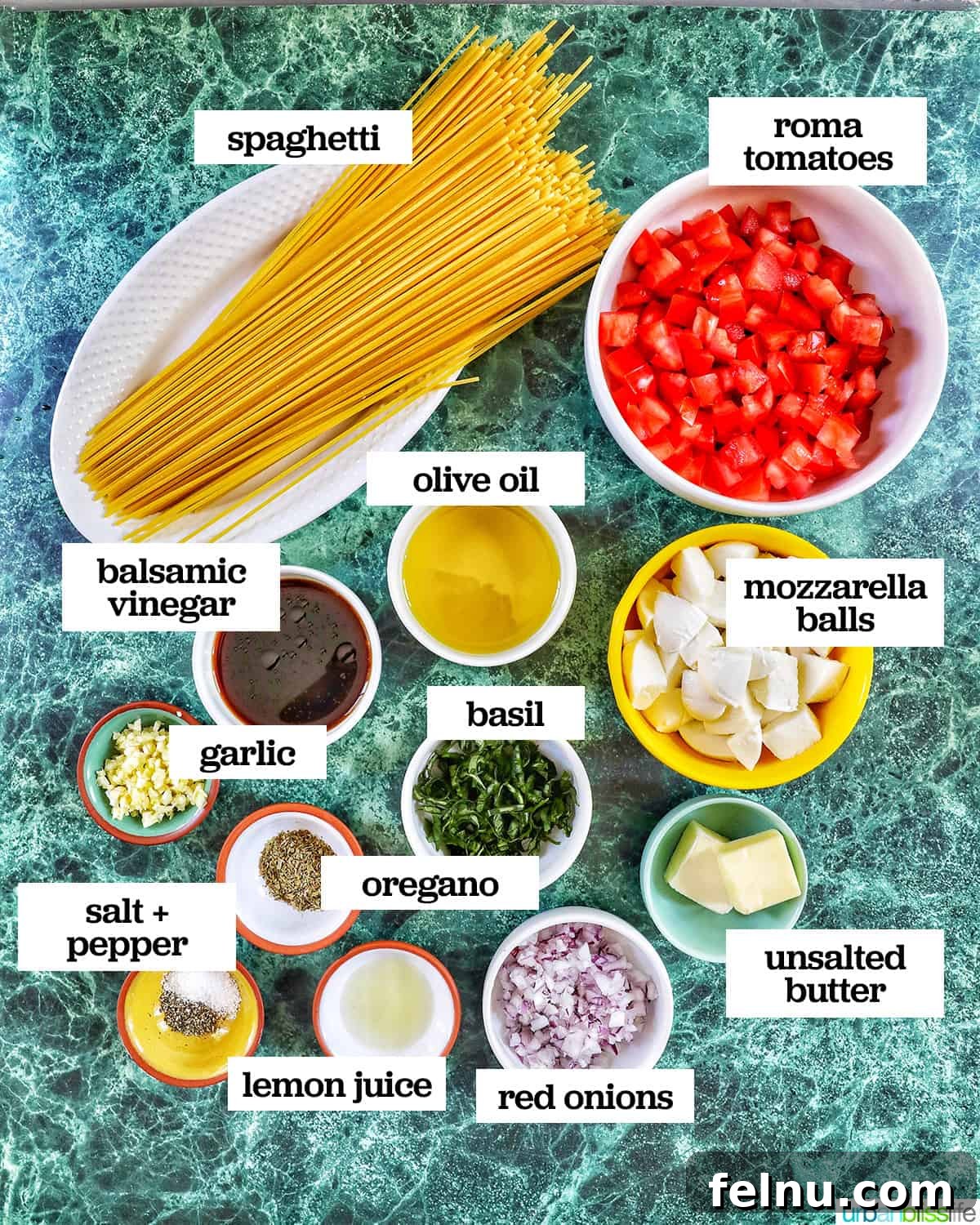 Bowls of ingredients to make bruschetta pasta on a table.