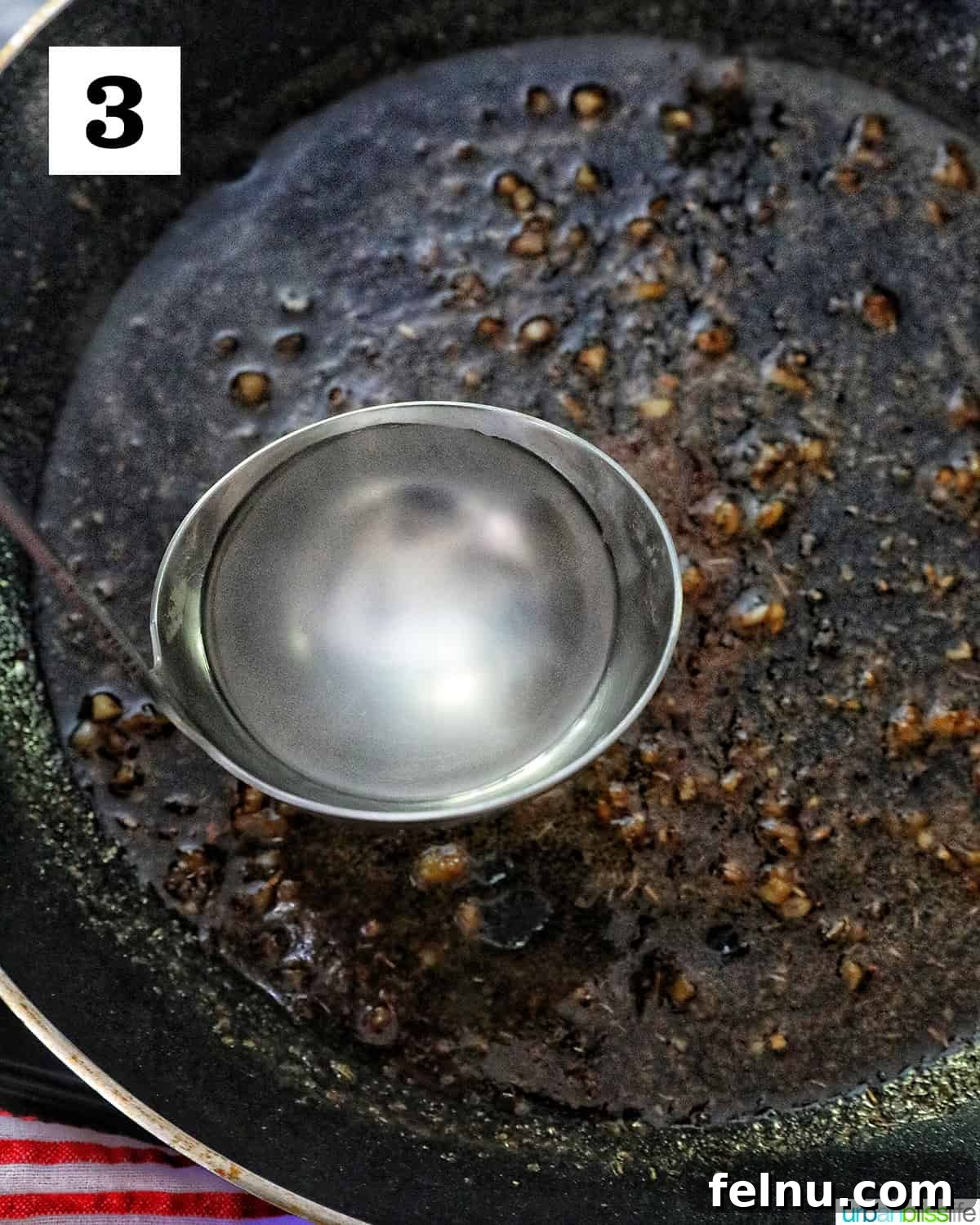 Ladle with hot pasta water going into a skillet.