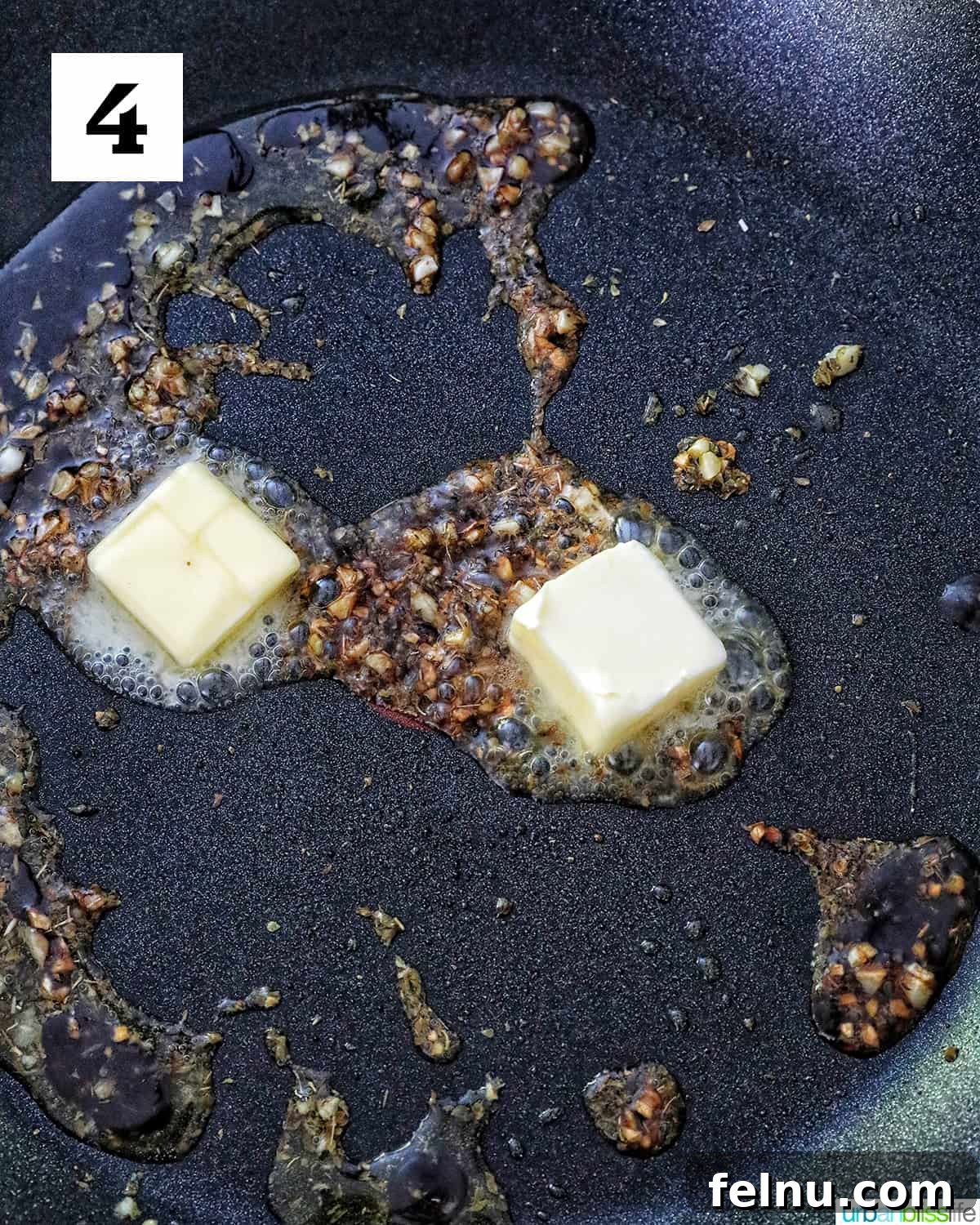 Butter in a skillet with garlic.