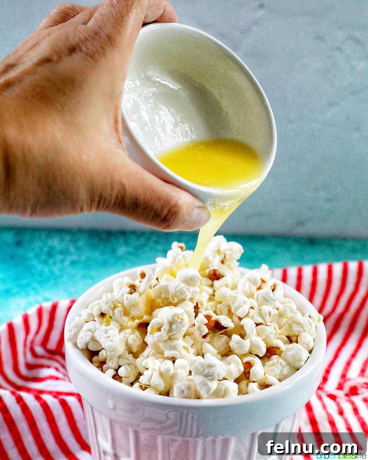 Instant Pot Popcorn Perfection 8 Pouring melted butter over Instant Pot Popcorn