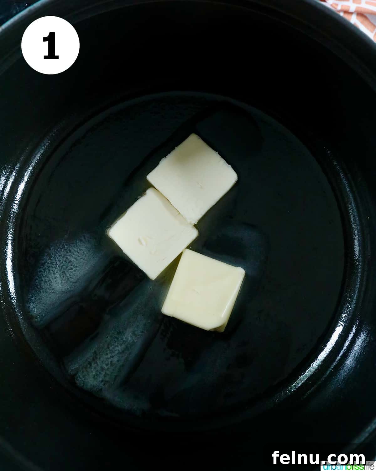 Seasonal Pumpkin Crunch Squares 5 Unsalted butter melting in a Dutch oven on the stovetop.