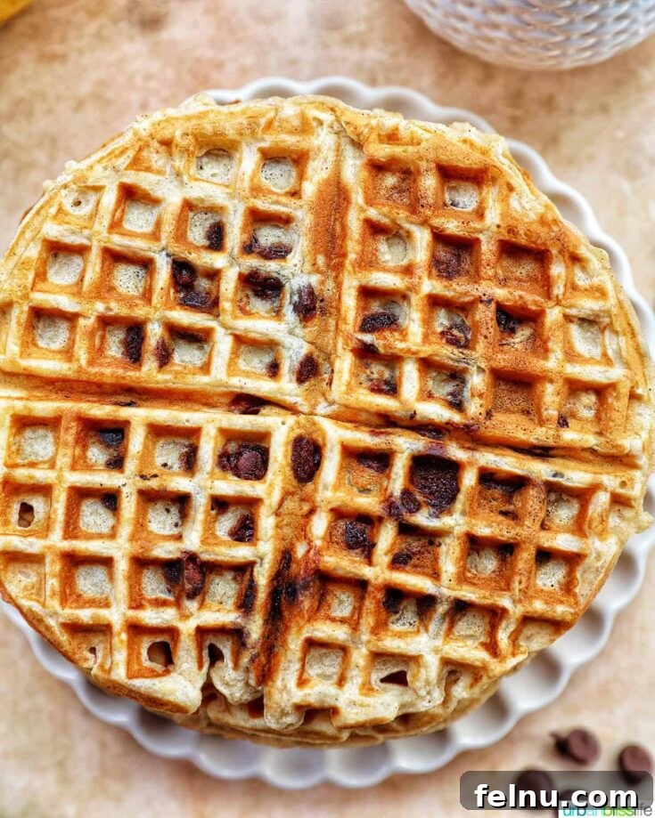 A stack of golden brown banana chocolate chip waffles.