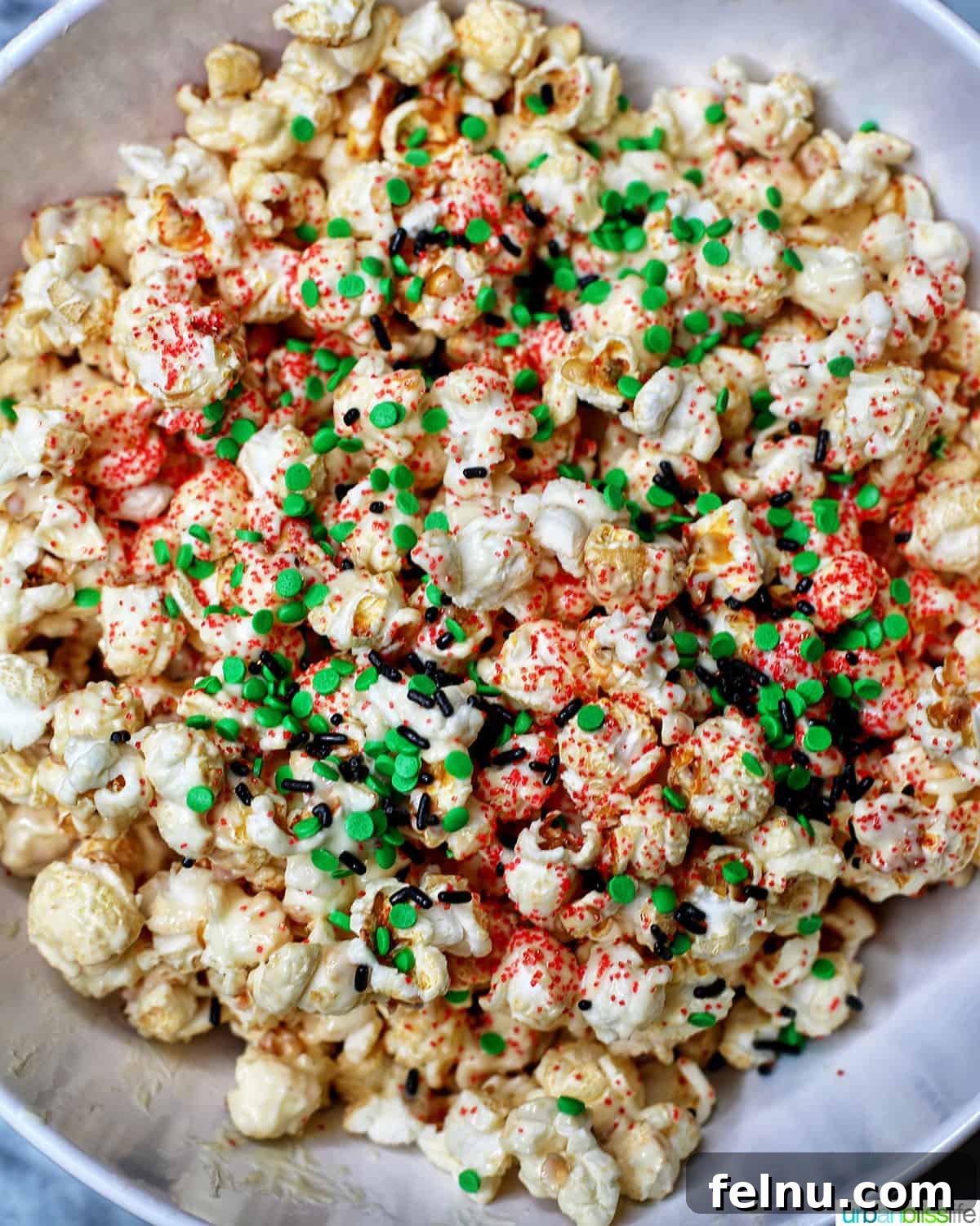 Festive Holiday Popcorn Mix 9 Christmas popcorn in a big white bowl.