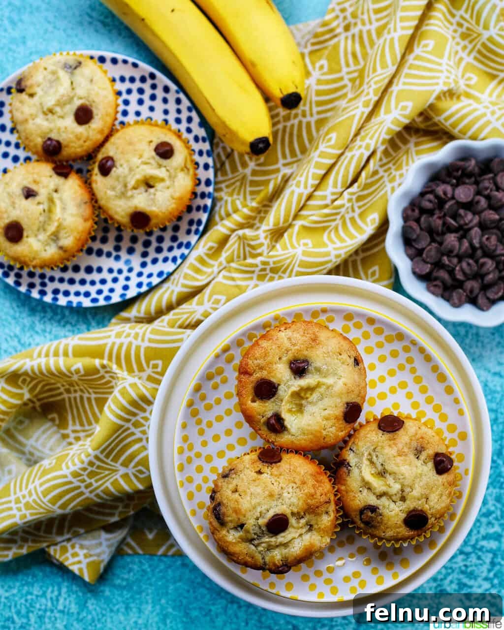 Banana Chocolate Chunk Muffins 3 Six banana chocolate chip muffins displayed on polka dot plates with bananas and chocolate chips.