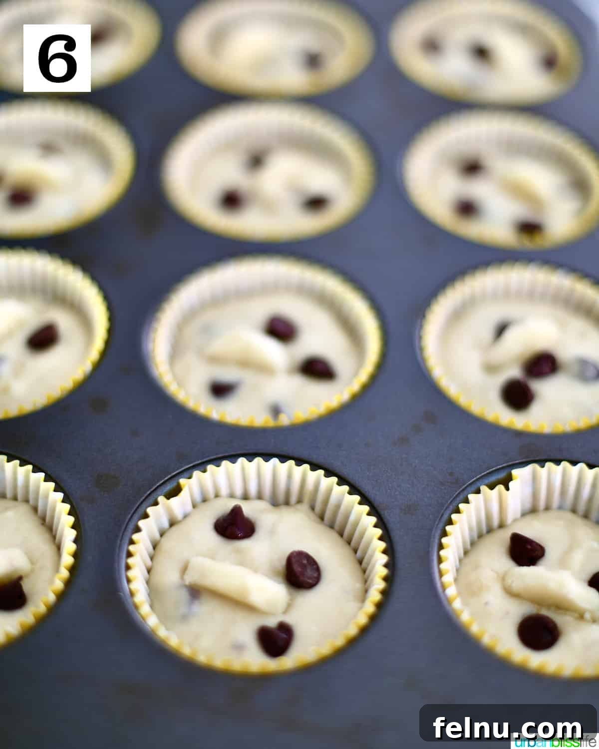 Banana Chocolate Chunk Muffins 10 Banana chocolate chip muffin batter in muffin tins.
