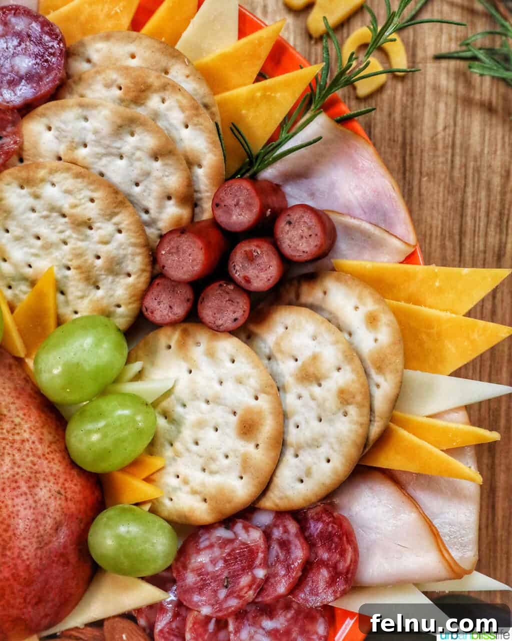 Gourmet Turkey Charcuterie Board 3 turkey, salami, crackers, cheese, grapes on a Thanksgiving charcuterie board.