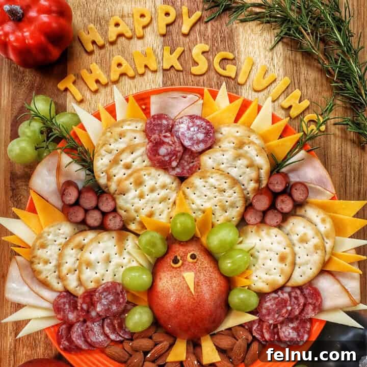 beautiful Thanksgiving turkey charcuterie board with cheese, meat, crackers, and fruit.