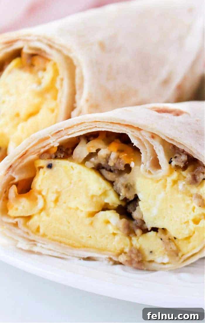 Air Fryer Breakfast Burrito cut open to reveal delicious fillings.