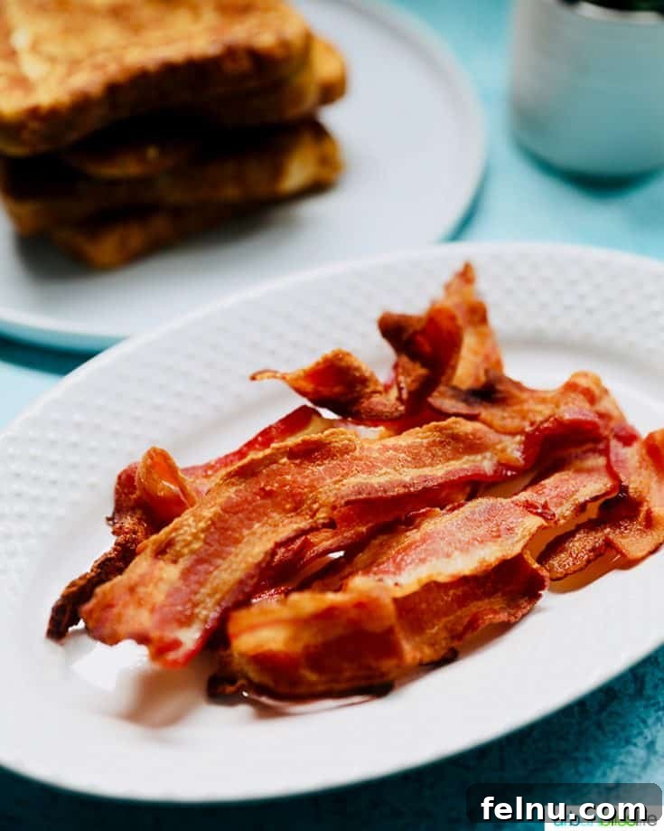 Crispy air fryer bacon served with buttered toast.