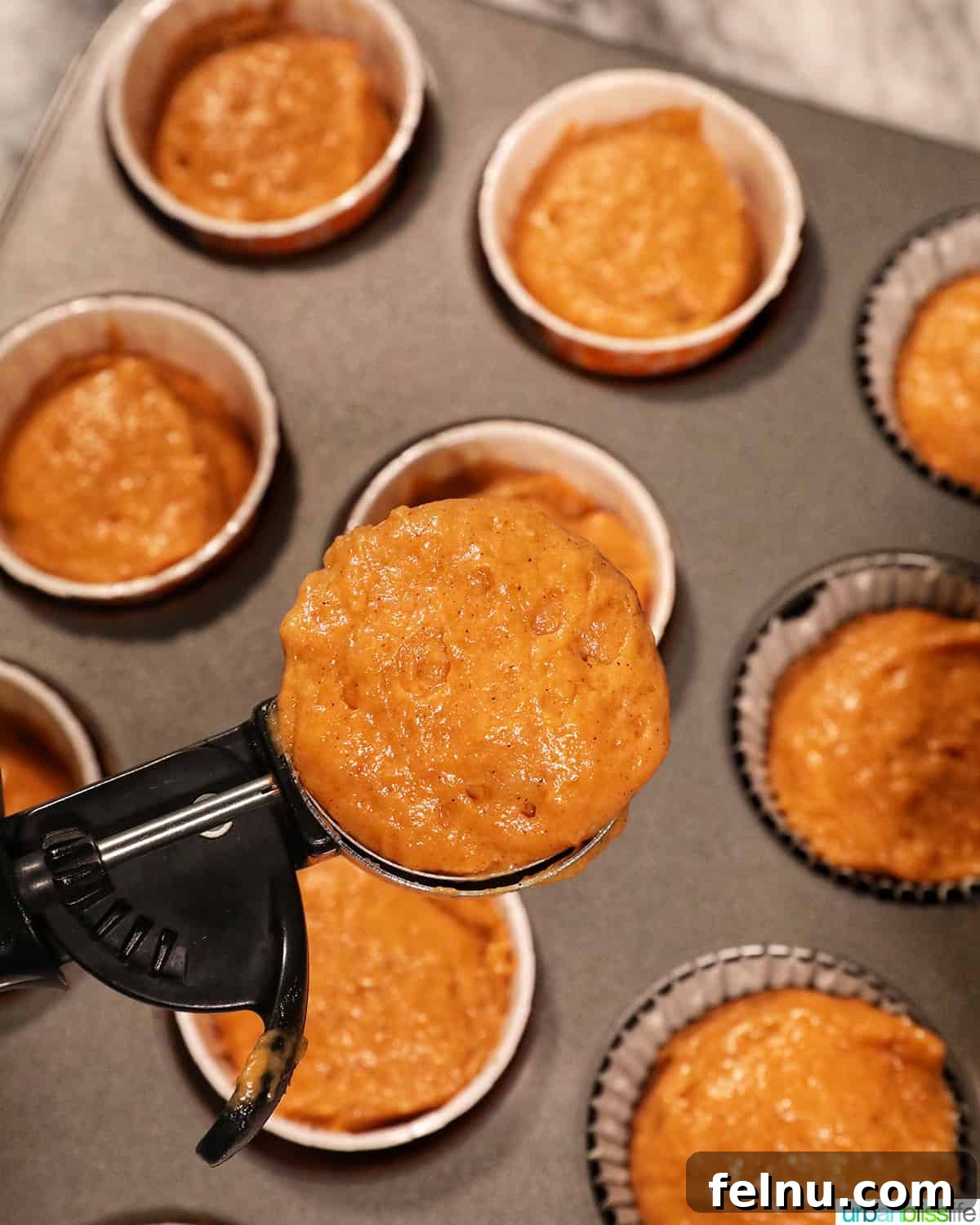 Pumpkin Banana Bliss Muffins 11 Scoop of pumpkin banana muffin batter to be put into the muffin cups.