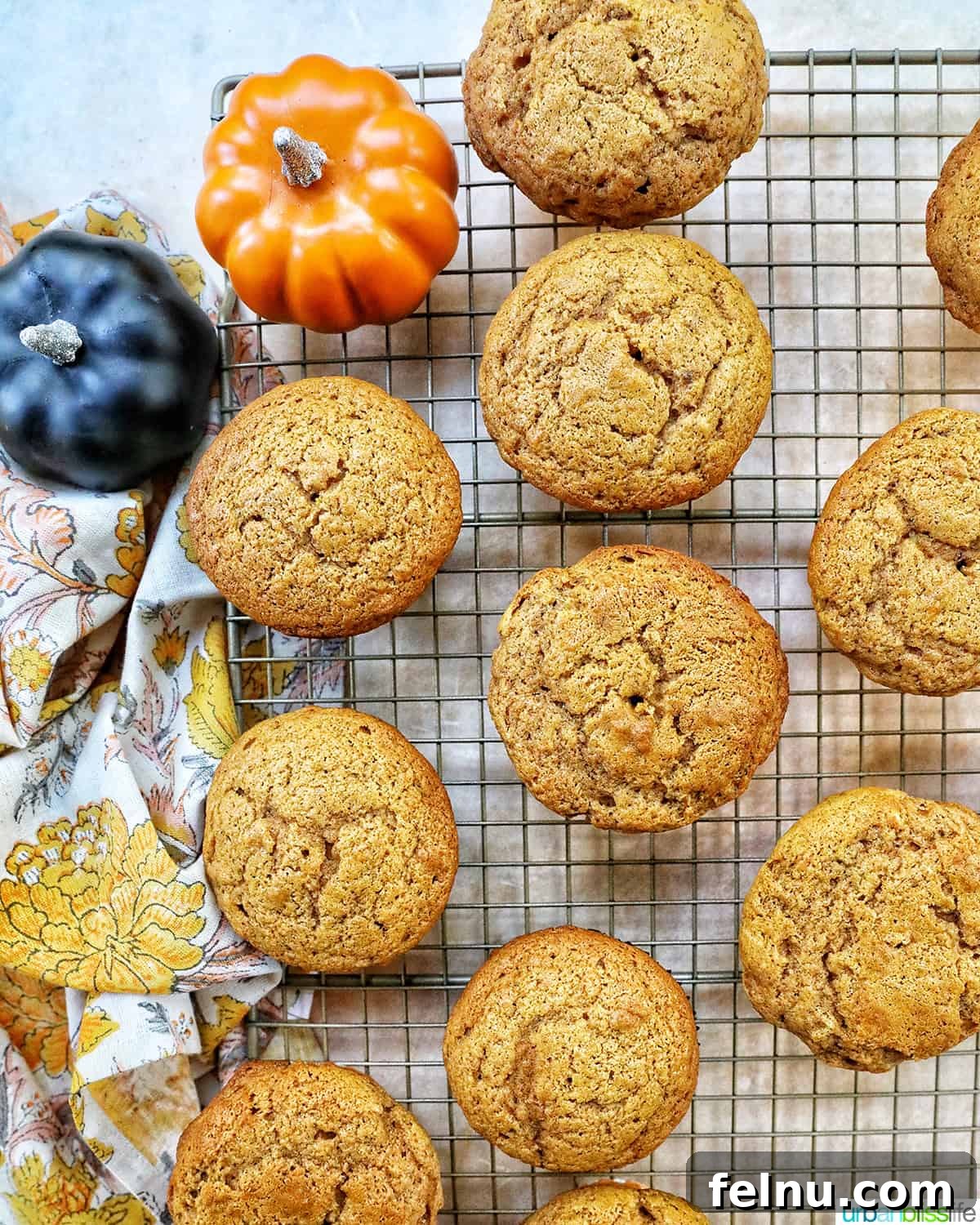 Pumpkin Banana Bliss Muffins 13 Pumpkin banana muffins on a cooling rack.