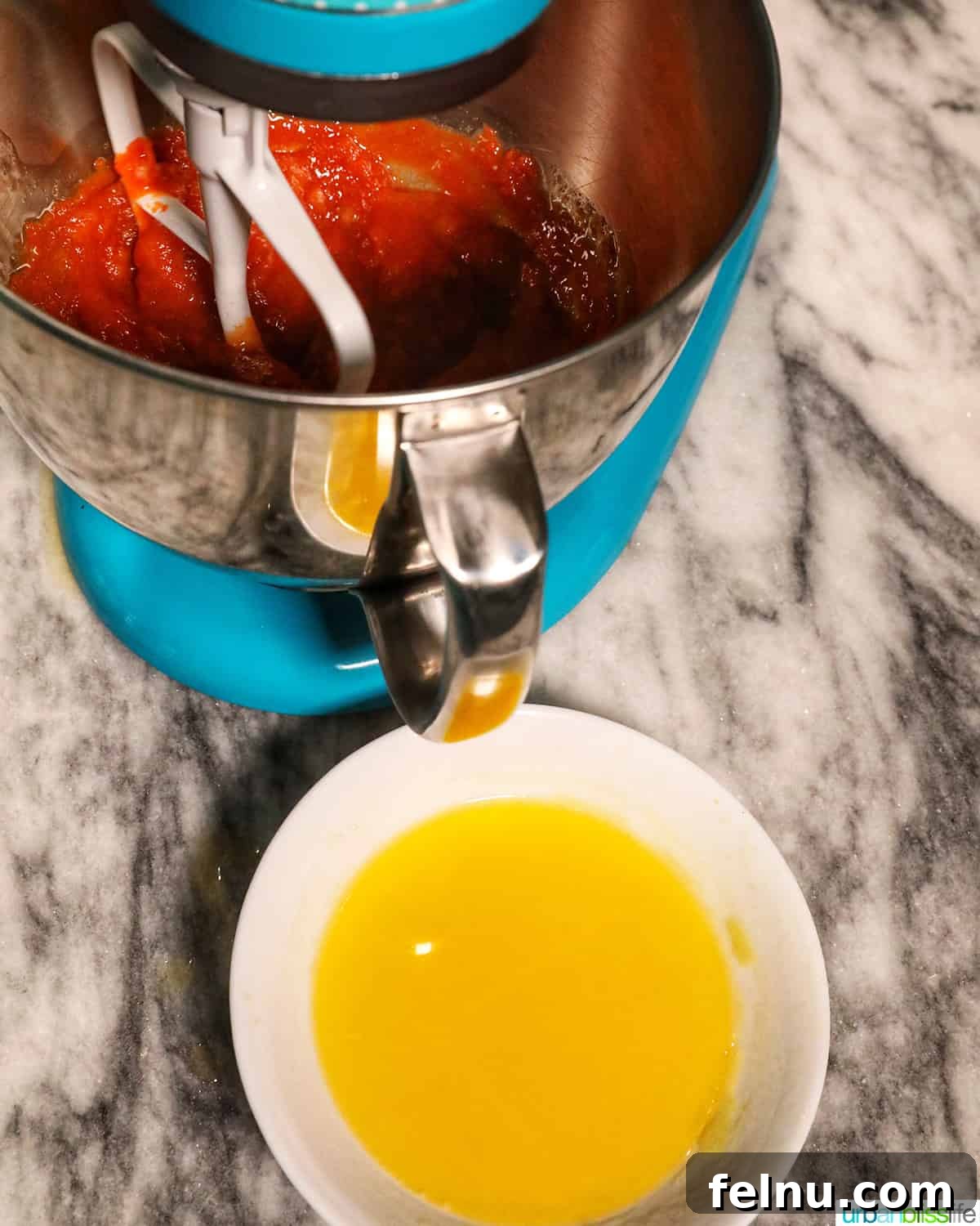 Pumpkin Banana Bliss Muffins 7 Blue stand mixer with melted butter.