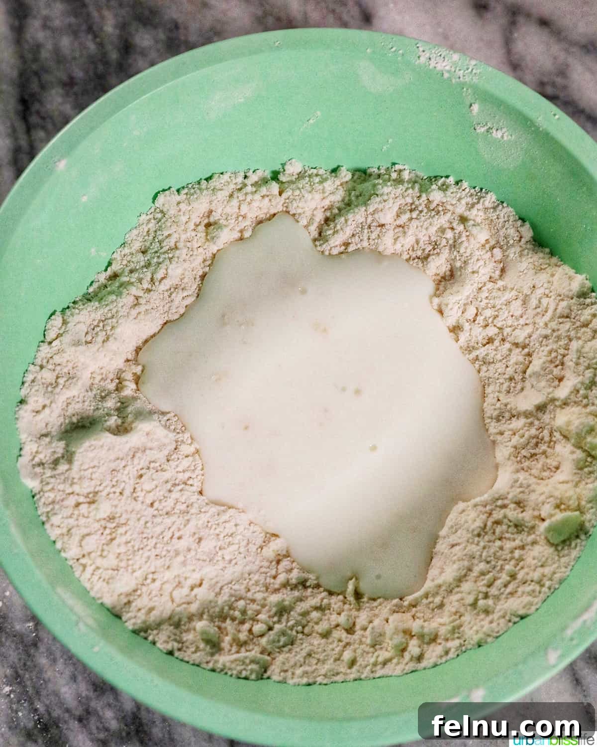 Fluffy Air Fryer Biscuits 7 buttermilk poured into a well of dry ingredients to make biscuits.