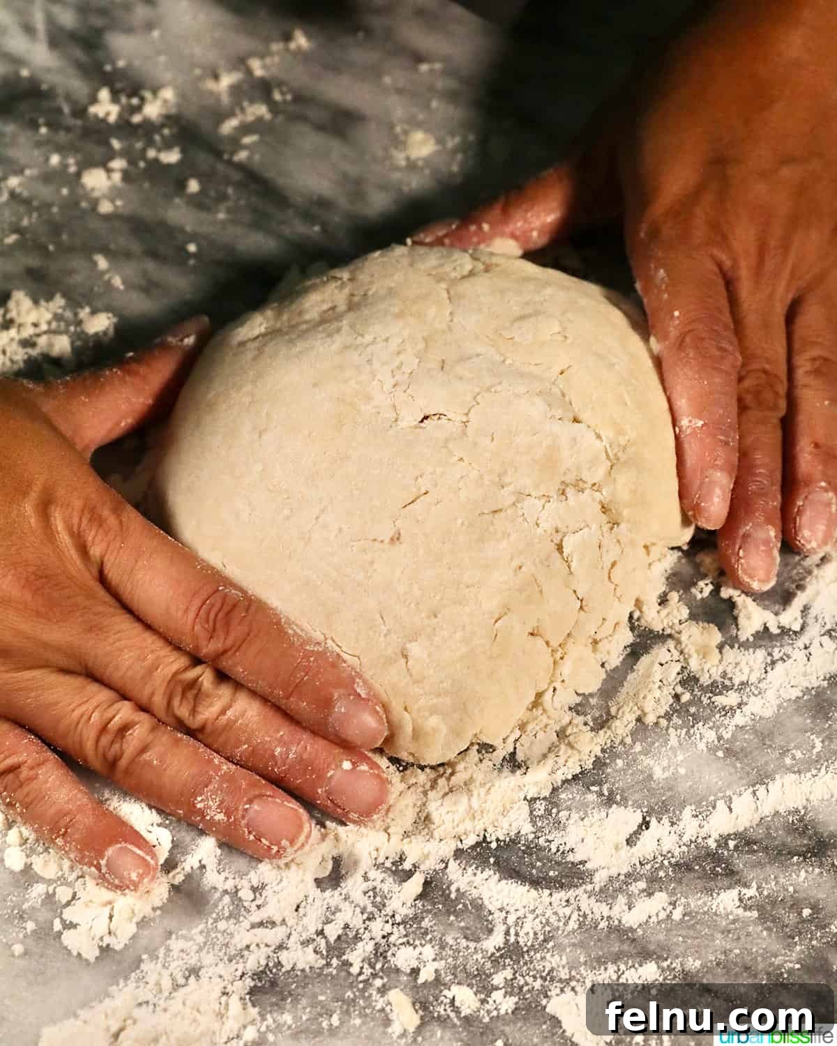 Fluffy Air Fryer Biscuits 8 hands shaping biscuit dough on a marble countertop.