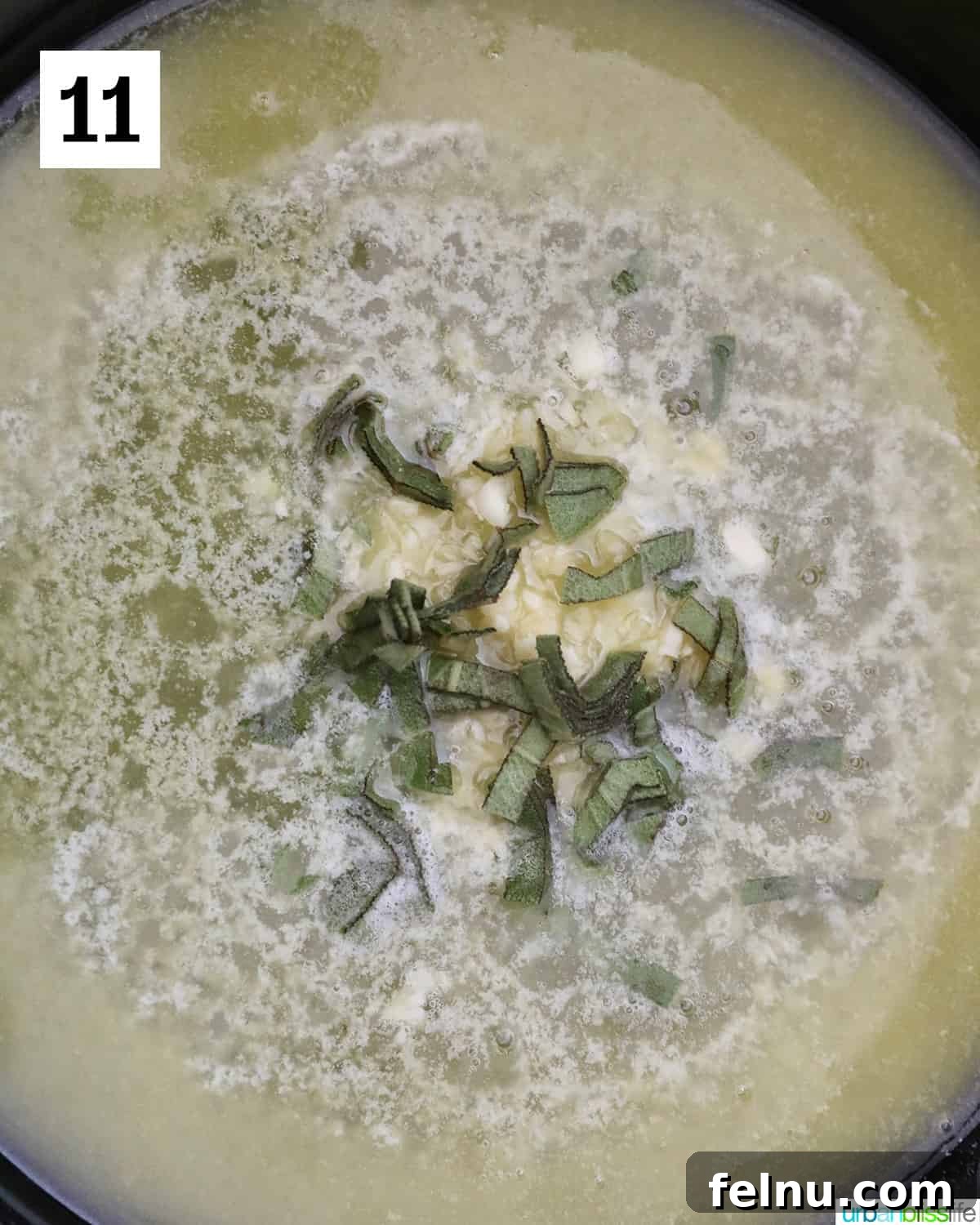 A vibrant butter garlic sage sauce is actively cooking in a pan, its aromas mingling as the ingredients simmer to perfection.