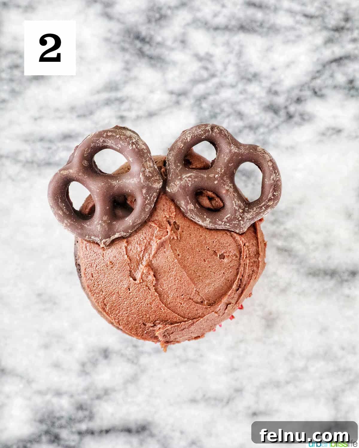 Reindeer Delight Cupcakes 14 Attaching chocolate-covered pretzels for reindeer ears