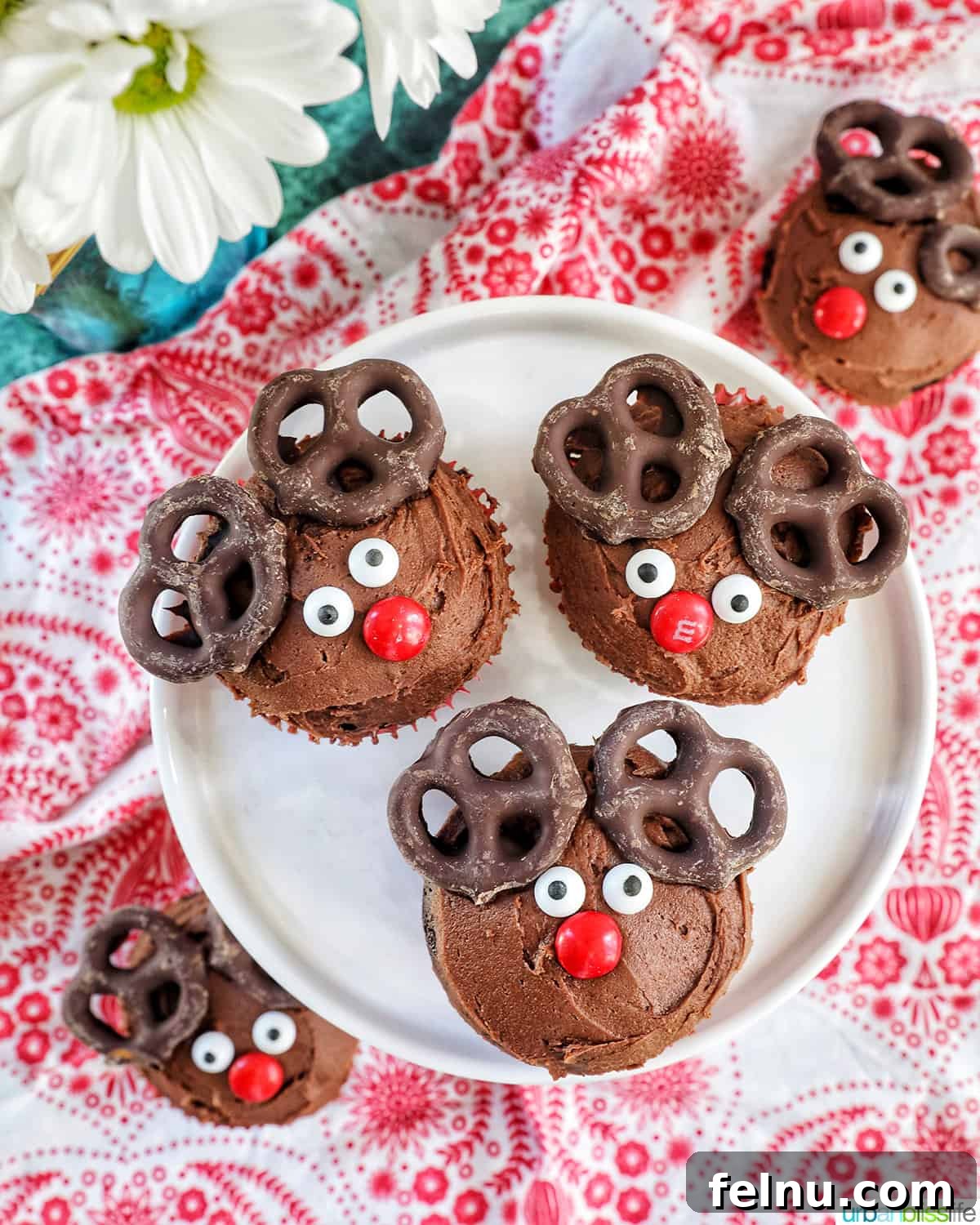 Reindeer Delight Cupcakes 3 Three reindeer cupcakes on a plate, close-up